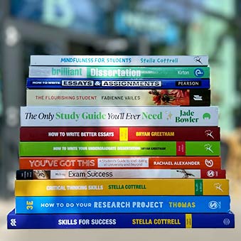 A pile of books in front of blurred lecture rooms